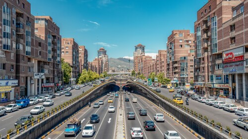 Traffic in Tehran, Iran, around the Tohid Tunnel, with the Alborz mountains in the background.