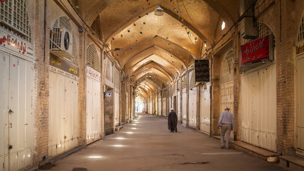 An empty corridor inside the Grand Bazaar of Isfahan, Iran, with closed shops.