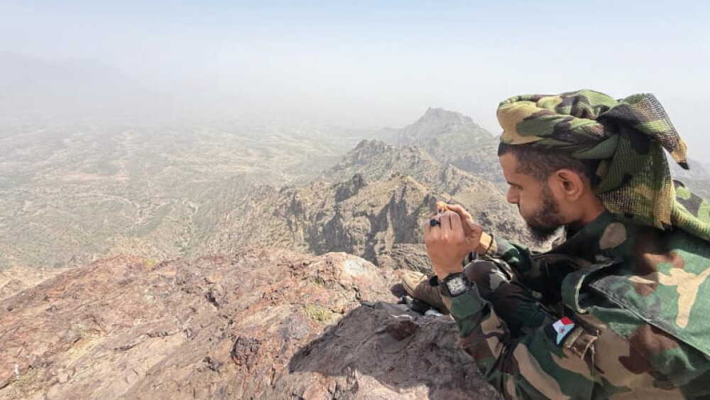 Fighter of the Southern Giants Brigades on a mountain overlooking frontline positions against the Houthis, Dhale province.