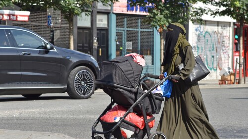 A Muslim woman pushing her baby carriage down Camden High Street, London, July 3, 2021. 'Muhammad' is now the most popular name for newborn baby boys in England and Wales.