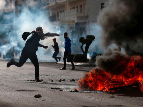 Palestinian demonstrators burn tires and throw rocks in the West Bank.