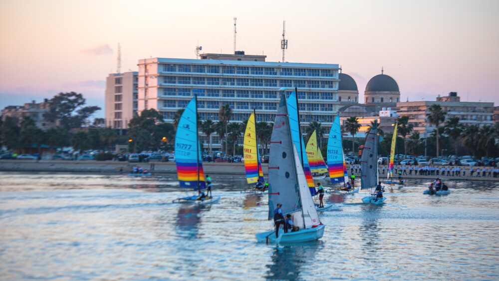 Benghazi is secure enough that even women and children hang out on the miles-long corniche that begins just across from it, even hours after dark. New developments have added to the skyline, and billions of dollars of retail investment have flooded the city. Cranes and construction are everywhere. Image: A 2023 boat show on Lake Benghazi.