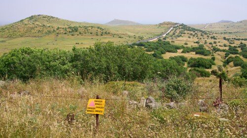 The restricted military zone along border between Israel and Syria in Golan Heights. A sign warns "Danger mines."