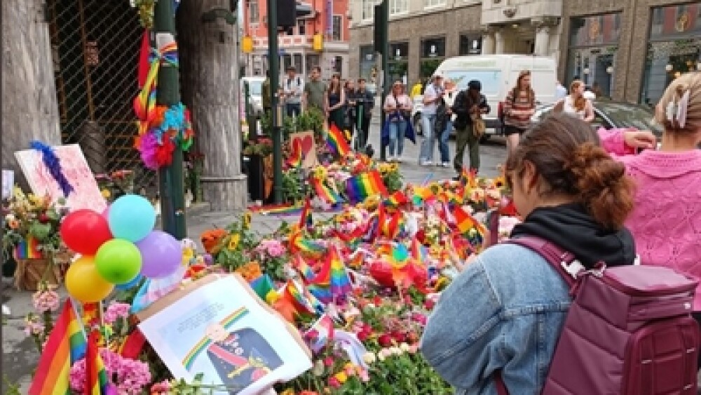 Mourners gather at a memorial established in the aftermath of an Islamist attack on a gay bar in Oslo on June 25. (Twitter photo.)
