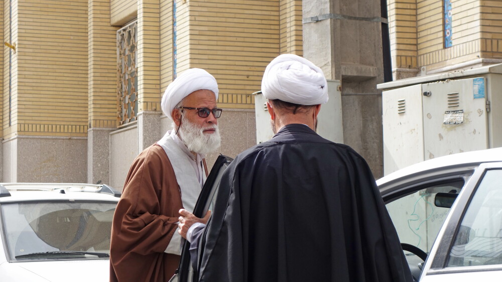 Two Muslim mullahs confer on a street in Qom, Iran, in December 2024.