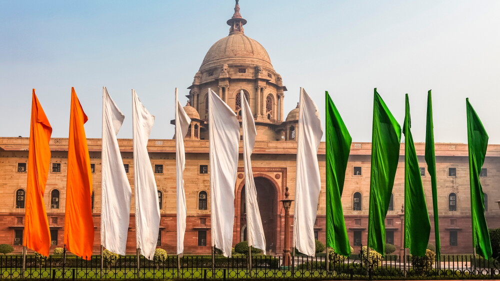 Flags in the colors of India's flag fly in front of a government building in New Delhi.
