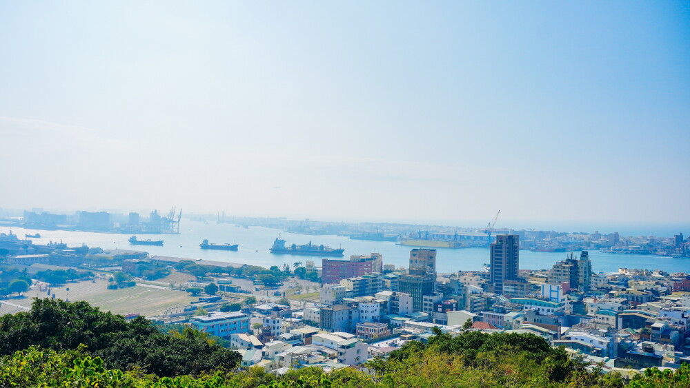 Kaohsiung Port harbor, downtown, the Taiwan Strait, and Shoushan Mountain in Taiwan.