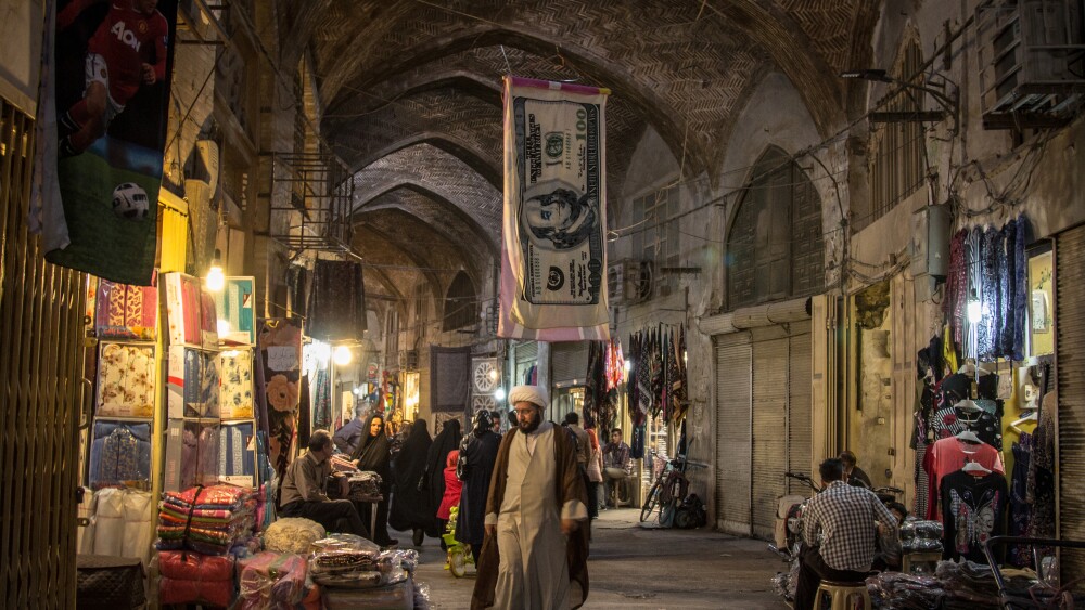 A towel printed like an American dollar hangs in a bazaar in Iran. European powers will trigger "snap-back" sanctions on Iran if it does not reach a nuclear deal with the U.S. by August.