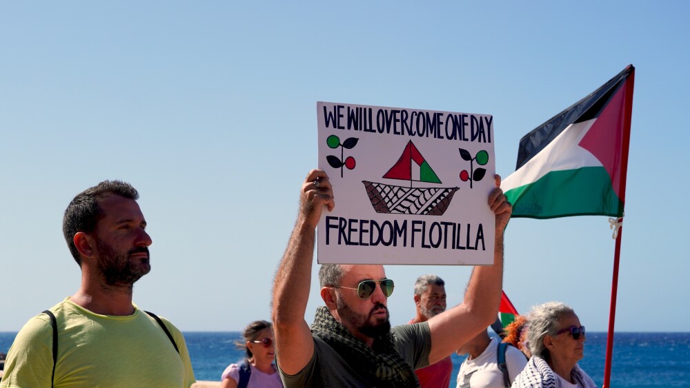 Spanish and Palestinian protesters held signs and flags in support of the Global Sumud Flotilla as it passed by Spain's Canary Islands in late August. Numerous reports indicate that the vessels, which were blessed by an Italian archbishop, carried no humanitarian aid.