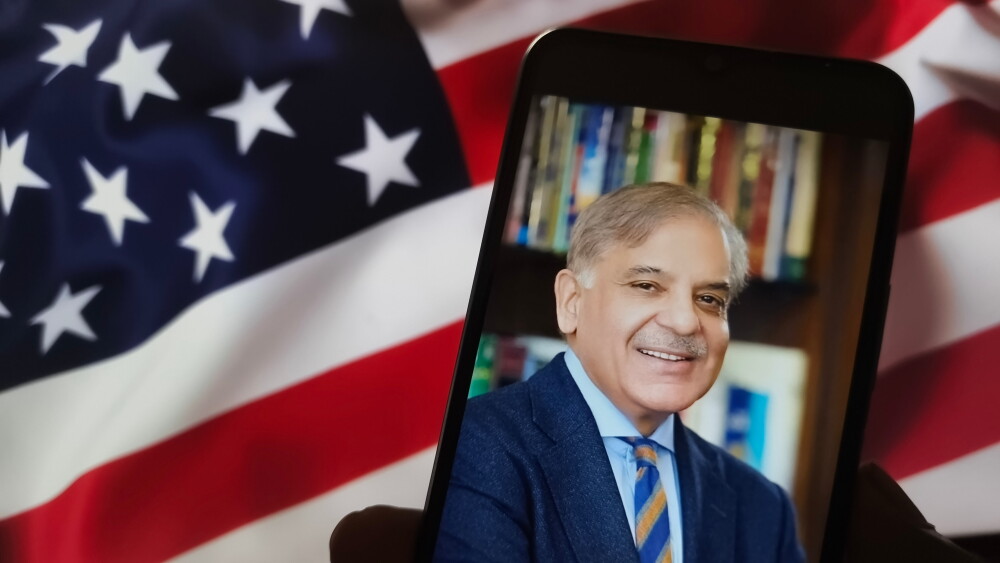 A smartphone shows an image of Pakistan's Prime Minister Shehbaz Sharif.