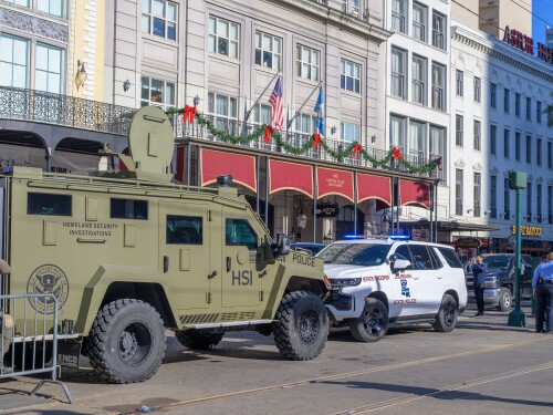 Police and armored vehicles on Canal Street near the entrance to Bourbon Street.