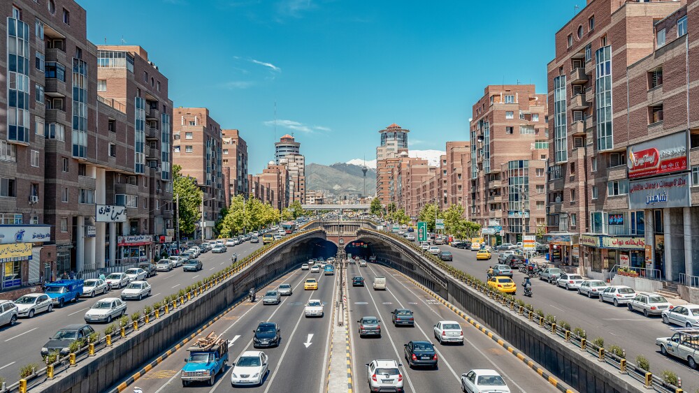 Traffic in Tehran, Iran, around the Tohid Tunnel, with the Alborz mountains in the background.