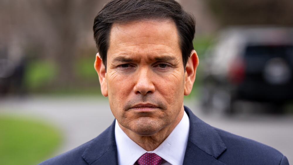 President Donald Trump recognizes that American investment is key to peace. But dire warnings increase insurance rates and dissuade businessmen who may not realize the warnings are decades out of date. Image: Secretary of State Marco Rubio speaking to reporters outside the Oval Office at the White House; March 20, 2026.