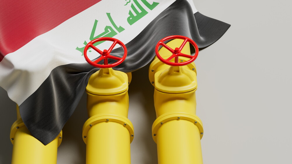 An Iraqi flag covers an oil pipeline.
