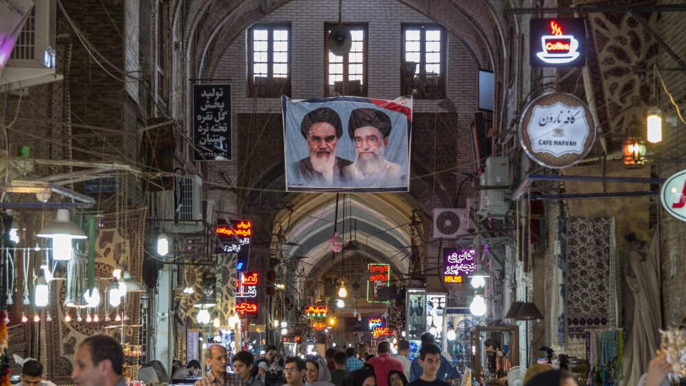 Portraits of Iran's two supreme leaders, Ali Khamenei and Ruhollah Khomeini, hang in a bazaar in Isfahan.  