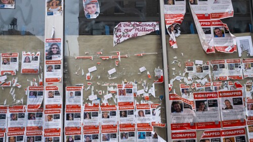 Posters of Israeli hostages are seen torn down from a wall in New York City.