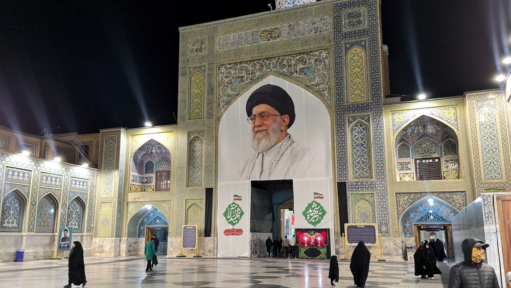 A large memorial banner of the late Supreme Leader Ali Khamenei at an entrance of the Imam Reza Shrine in Mashhad, Iran.