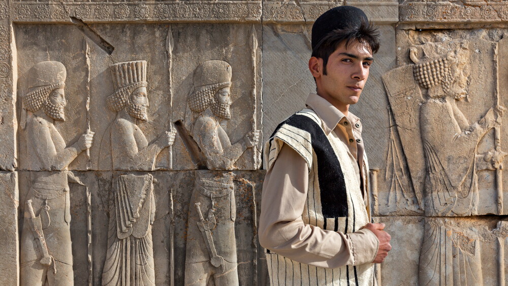 Iran’s sense of nationhood predates the ethno-nationalism around which European states began to organize in the 19th century. Iranians see a near-contiguous history dating back to the Persian Empire of millennia past. Image: an ethnic Bakhtiari young man in his traditional clothes, with ancient Persian reliefs behind him, in Persepolis, Iran; April 2, 2018.