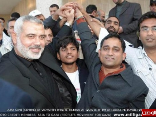A picture of Georgetown academic Badar Khan Suri (far right) celebrating with Hamas leader Ismail Haniyeh (left).