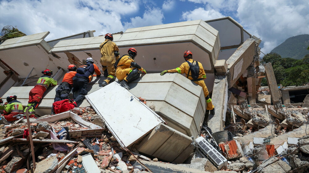 Rescuers work at the site of a collapsed building in the aftermath of the devastating earthquakes in Venezuela as recovery operations continue in July 2026.